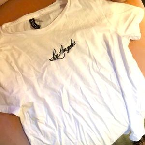 White cropped shirt from H and M that says Los Angeles